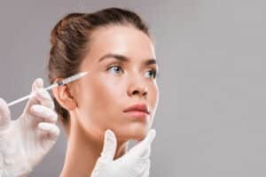 Attractive woman in her early 30s receives Botox injections to delay the formation of crow's feet