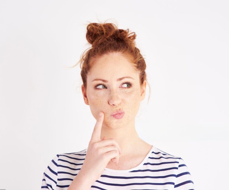 Woman with hand on chin thinking