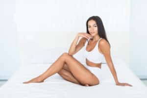 Brunette woman in undergarments has sleek contours after targeting stubborn fat with liposuction.